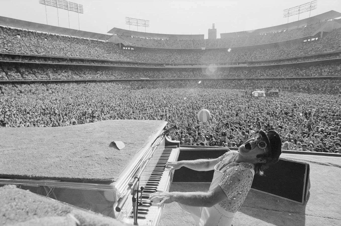 Elton John in stage costume and sunglasses